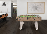 Foosball table in a modern kitchen with a map on the wall